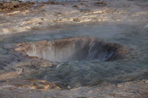 Pool of Strokkur Geysir Geyser refilling after eruption