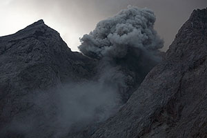 Evening eruption against light, Batu Tara volcano