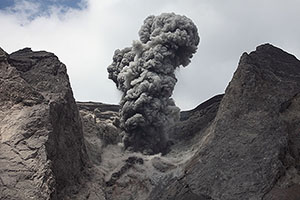 View of small ash-rich eruption of Batu Tara from boat