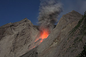 Ash cloud lit up by eruption below, Batu Tara volcano