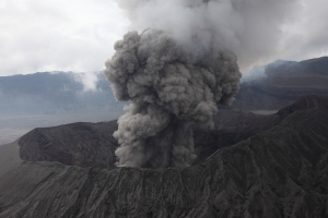 Bromo Volcano erupting ash. View from Batok cone. 