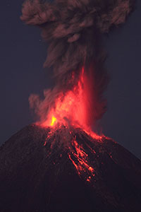 Powerful strombolian / vulcanian nighttime eruption throwing glowing lava high in air , Fuego de Colima volcano, Mexico