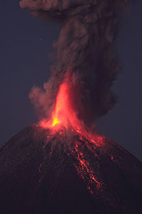 Powerful strombolian / vulcanian nighttime eruption throwing glowing lava high in air , Fuego de Colima volcano, Mexico
