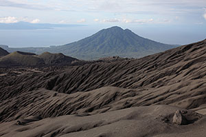 Volcanic bomb crater on Dukono with Mamuya volcano in distance