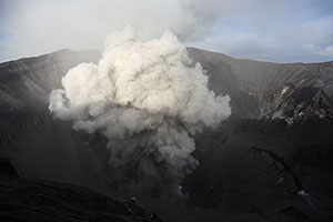 Crater of Dukono volcano, ash eruption.