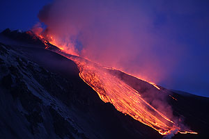 Paroxysmal eruption, Mount Etna Volcano, April 1st 2012. Lava flows in blue hour.