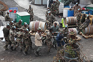 Soldiers salvaging wine barrels, Portela, Fogo Volcano Eruption, 2014