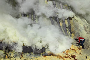 Kawah Ijen volcano, Solfatara, Sulfur Mine, Sulphur, Worker breaking up deposits