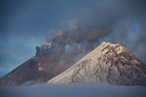 Kliuchevskoi volcano erupting ash and lava flow, Kamen on right