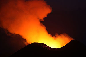 Nyamuragira Volcano crater glowing during blue hour