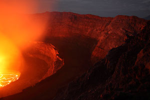 Nyiragongo volcano, lava lake illuminating crater at night