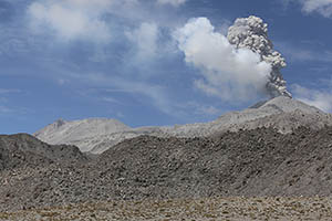 View of Ampato-Sabancaya erupting from NNE. Huge prehistoric andesite block flows in foreground